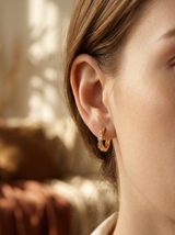 Woman wearing Rena Huggie Earrings - best earrings for sensitive ears guide