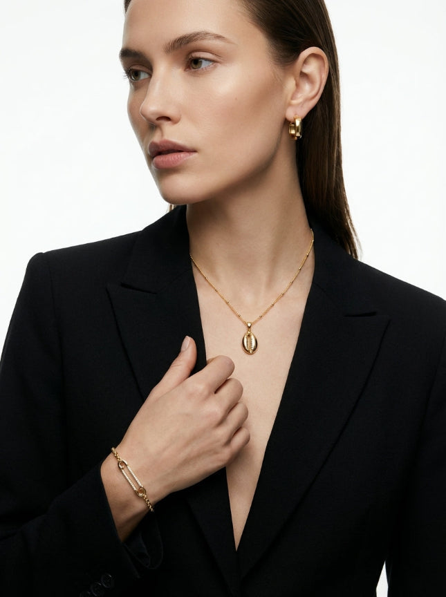 Cora cowrie shell necklace styled in a coastal jewelry set