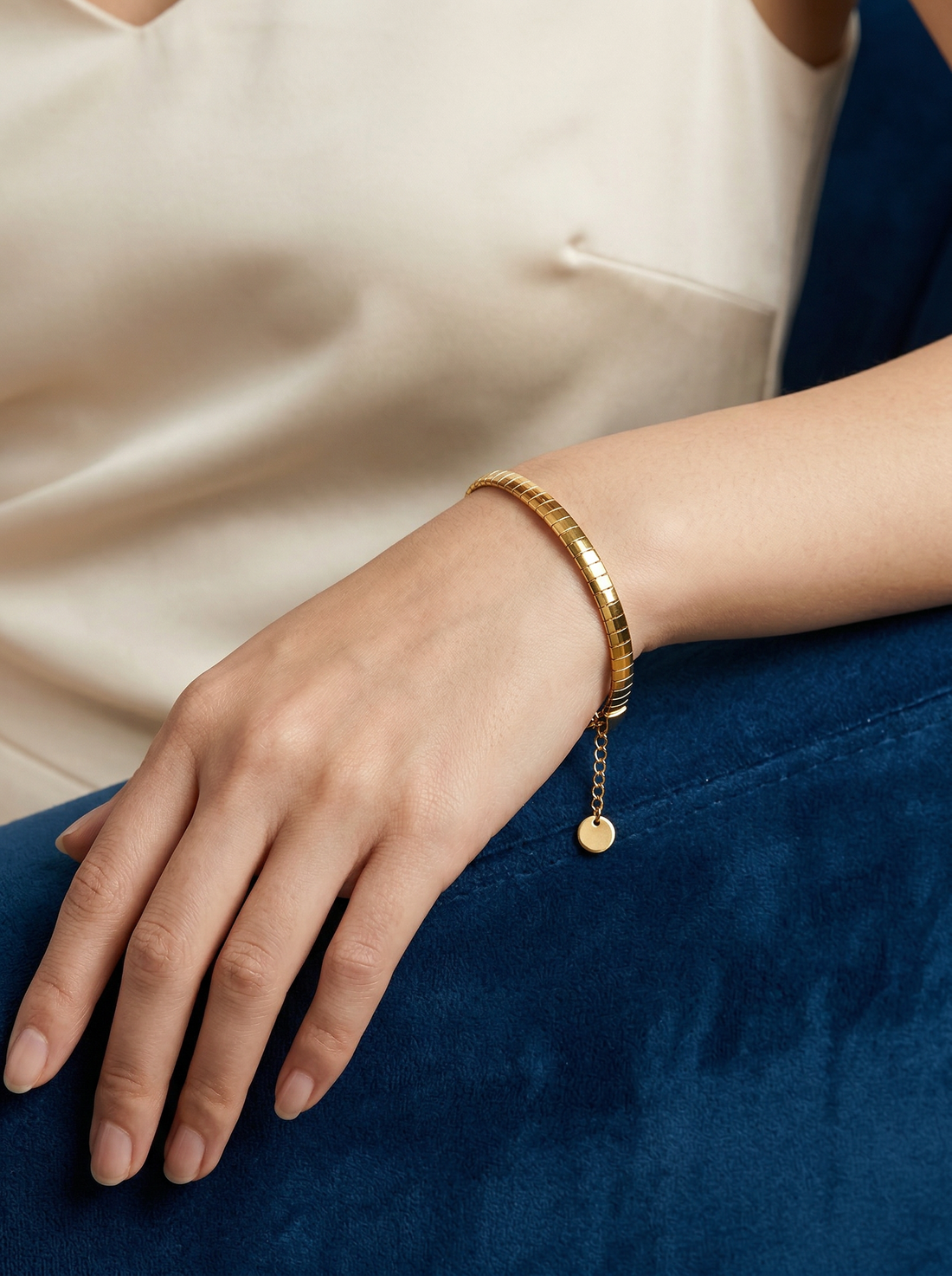 Model wearing Arlo Slim Flat Box Chain Bracelet in gold