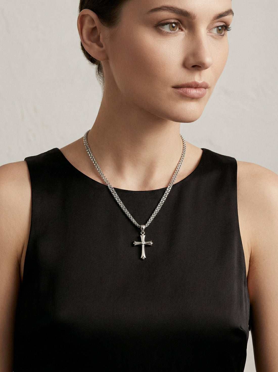 Model wearing Cruz Ornate Cross Pendant Necklace in silver from HyraMode