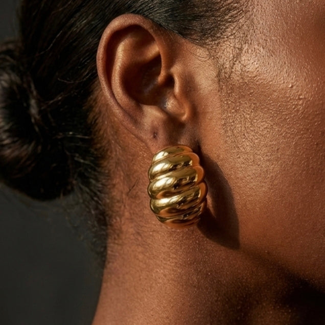 Gold jewelry styled in warm travel scene setting