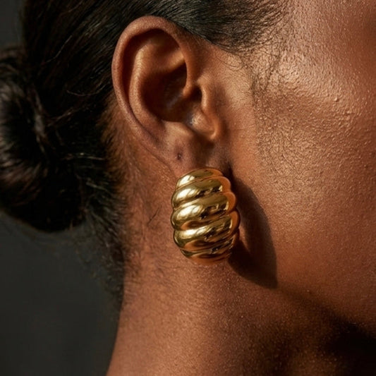 Gold jewelry styled in warm travel scene setting