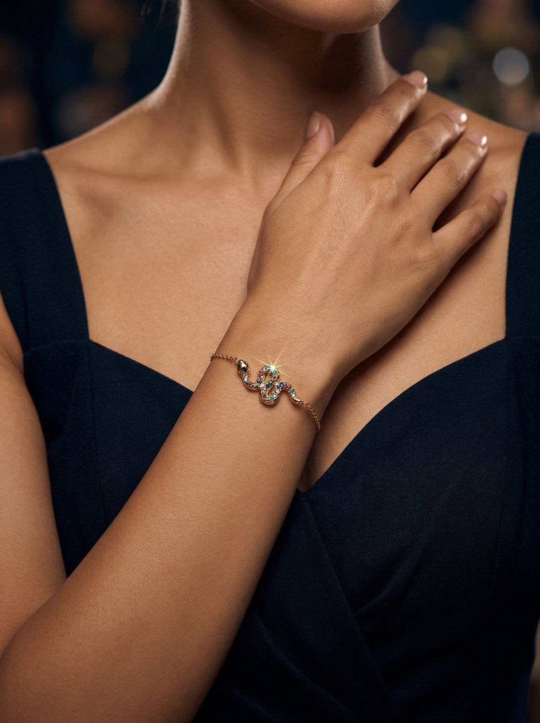 Model wearing Evia Dainty Chain Snake Reversible Charm Bracelet in gold — snake chain jewelry HyraMode