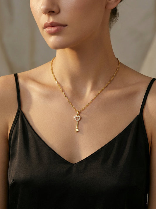 Woman wearing the Kaia Heart Key Pendant Necklace in gold — perfect jewelry for a baby shower guest