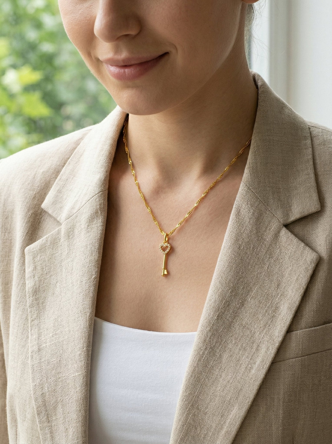 Gold heart key pendant necklace on model, Mother's Day jewelry gift 2026