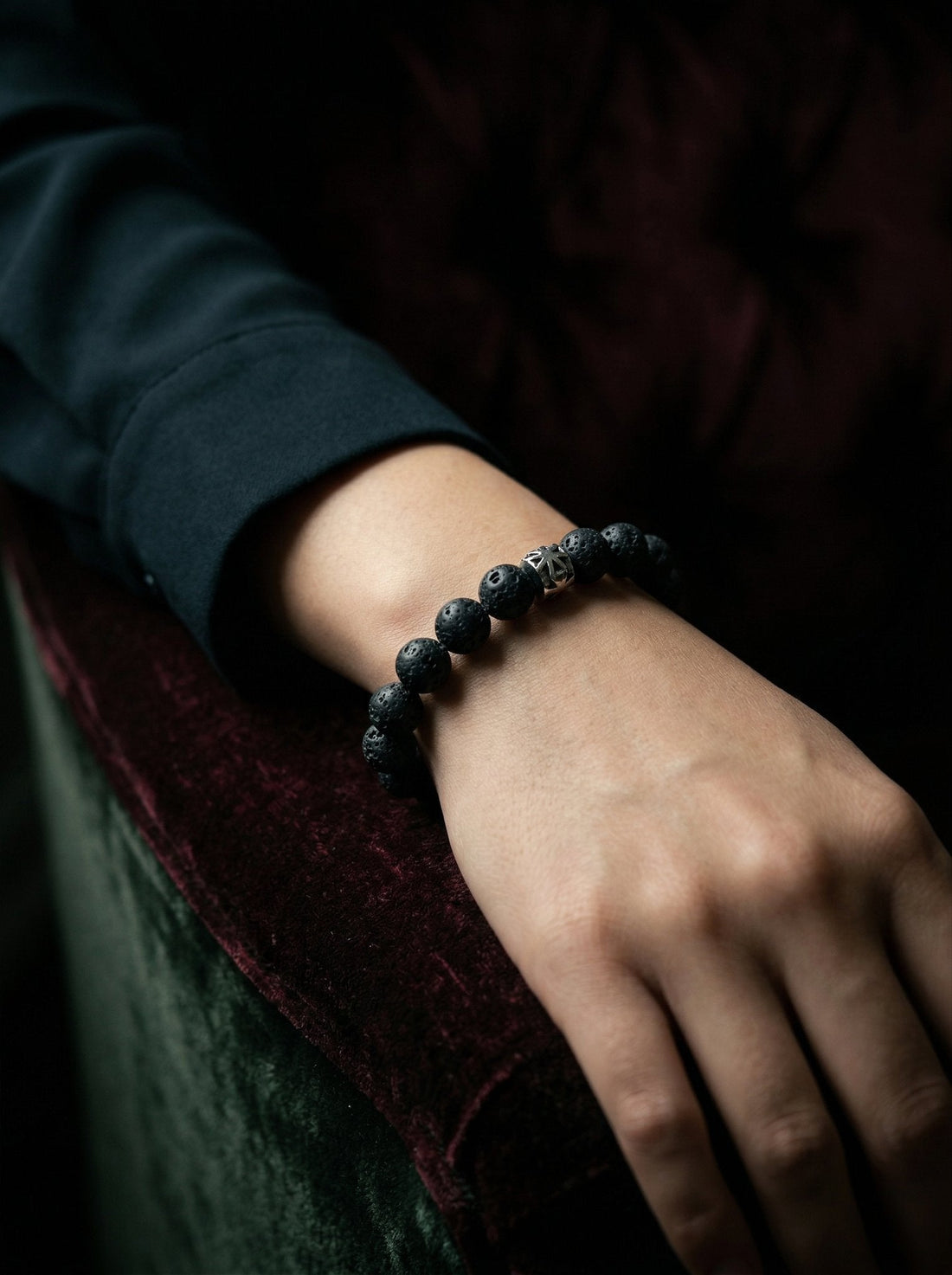 Woman wearing Kova Lava Stone Beaded Bracelet with silver-toned accents — HyraMode