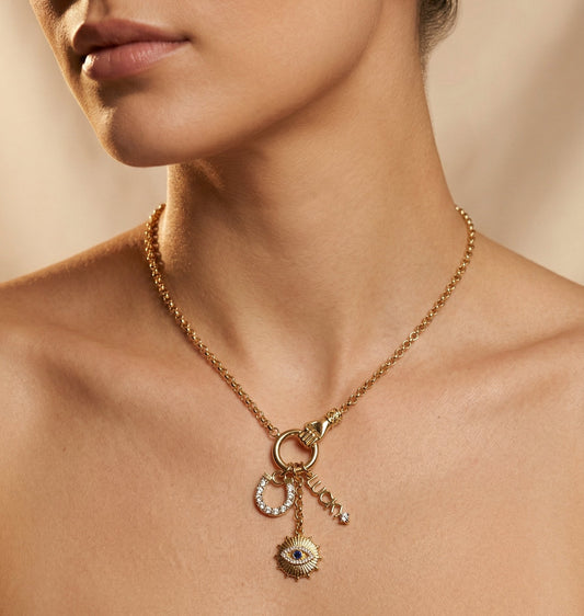 Woman wearing the Lena Gold Victorian Hand Talisman Necklace layered with gold chains