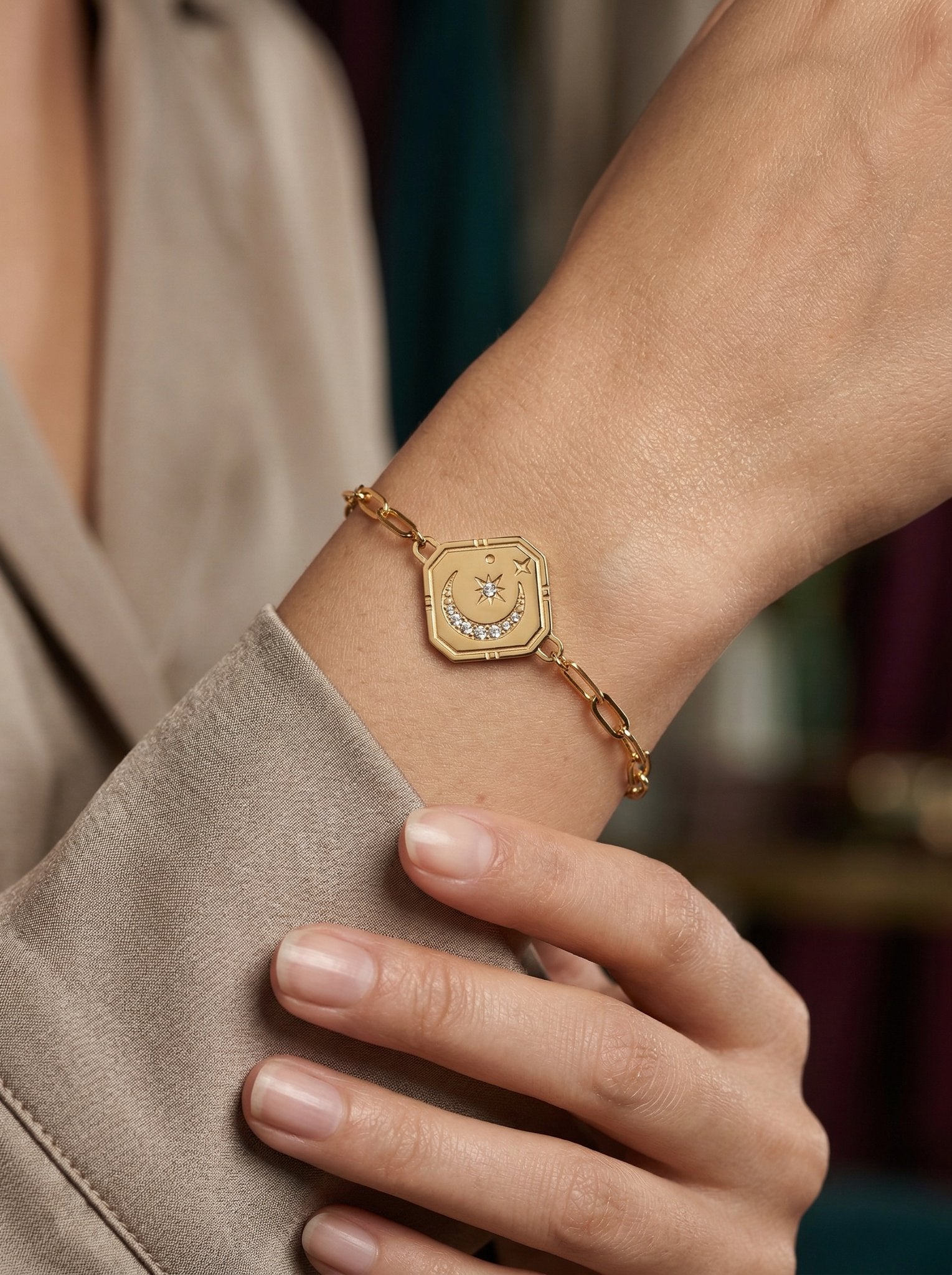 Model styling a gold paperclip bracelet with a relaxed everyday outfit