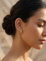 Baby proof jewelry - Woman wearing safe huggie earrings