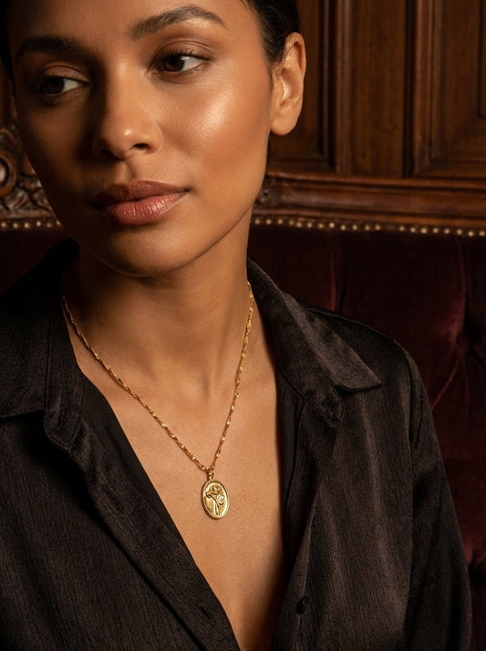 Woman wearing the HyraMode Rosa Rose Coin Pendant Necklace in gold tone, styled for everyday wear