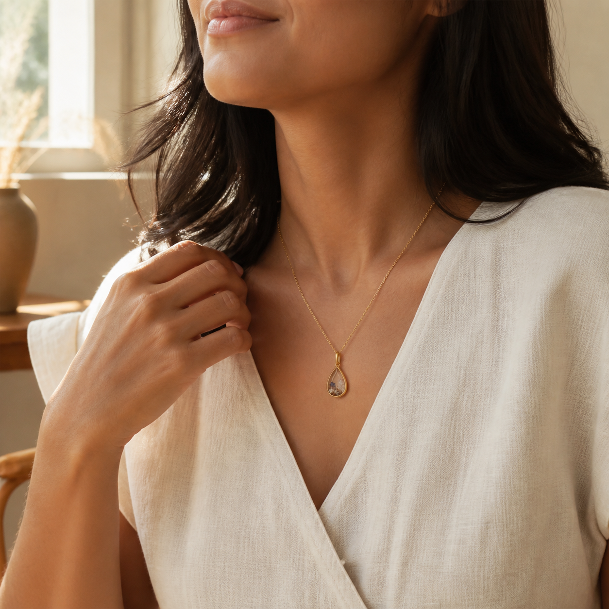 Woman wearing the Aria Teardrop keepsake memory locket necklace