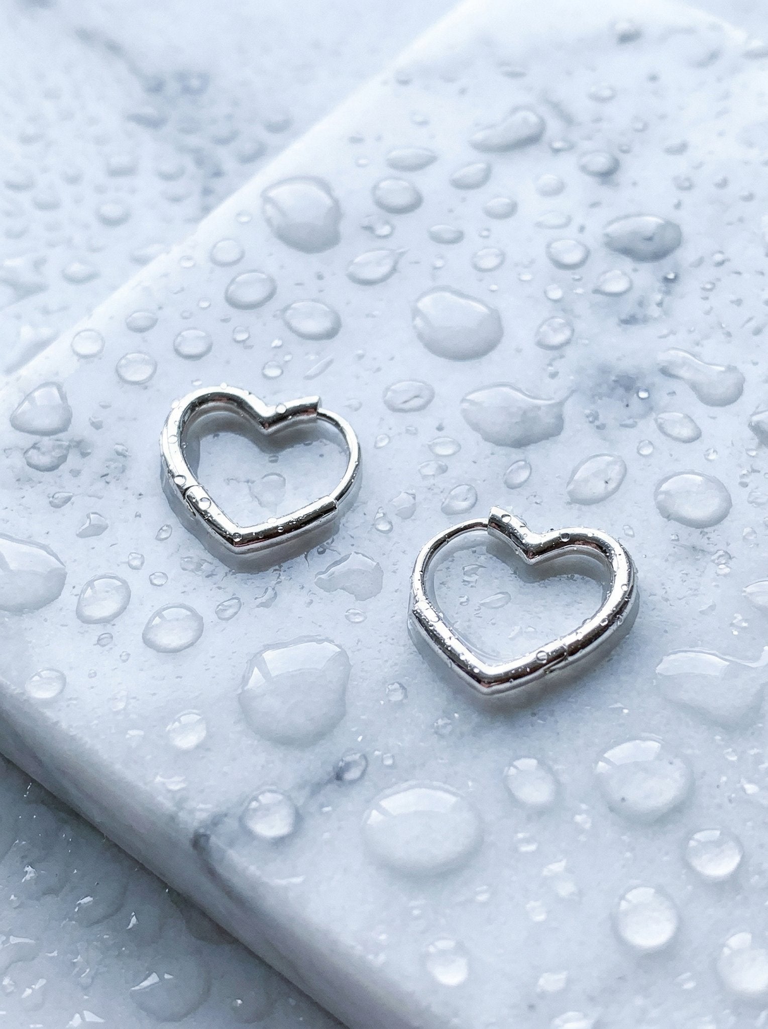 Gold ear cuff paired with silver huggie for mixed-metal contrast