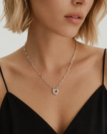 Silver Remy paperclip chain heart necklace worn by a model