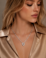 Close-up of silver Remy paperclip chain heart necklace on a model