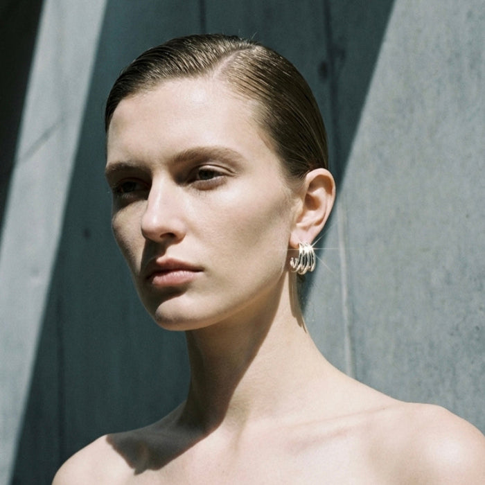 Tria Triple Hoop Stud Earrings in gold, angled view