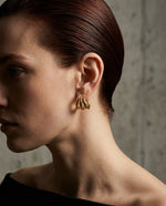 Tria Triple Hoop Stud Earrings in gold, styled on-ear view